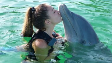 A woman with a dolphin.