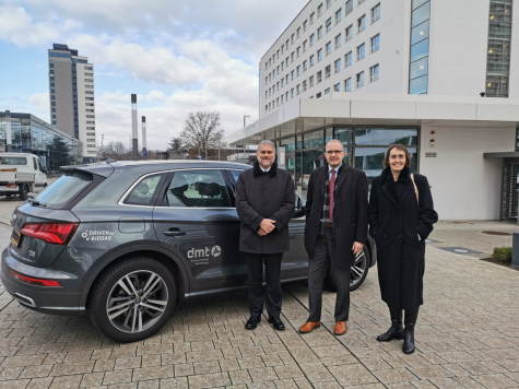 Image shows the delegation beside a biomethane powered car to discuss the AD industry's commitment to deliver major emissions reductions by 2030