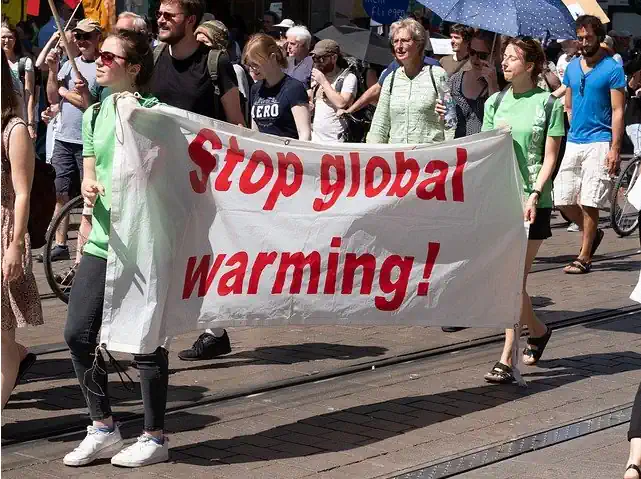 Image has text: "march to stop global warming but climate geography varies".